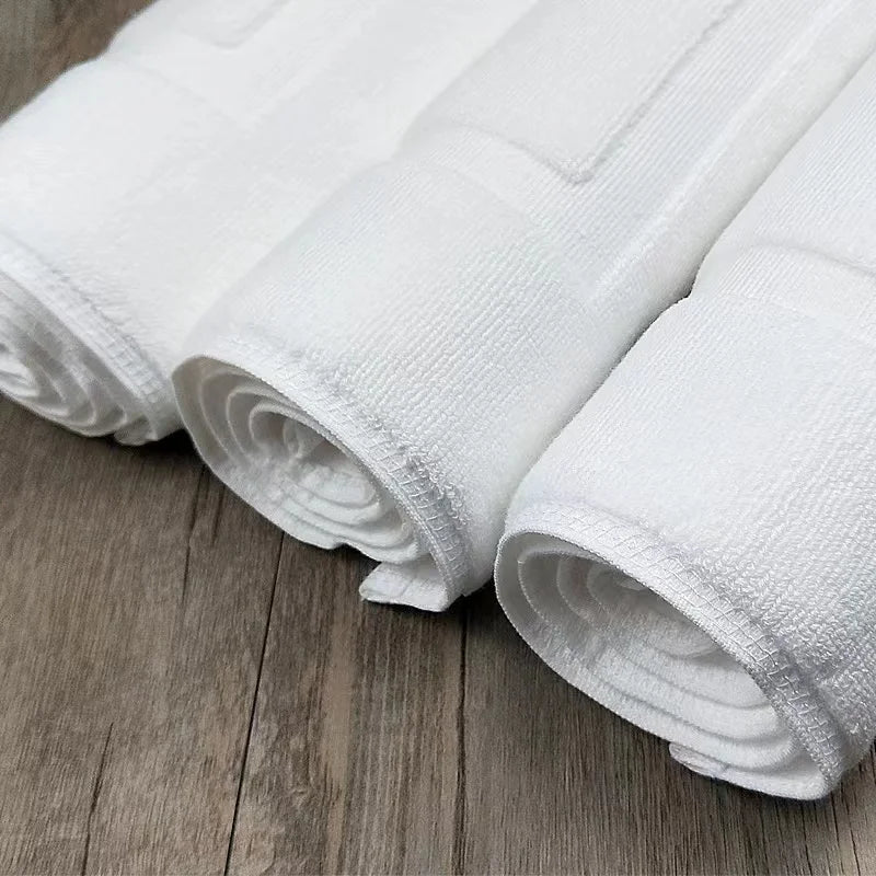 Rolled white cotton bath mats